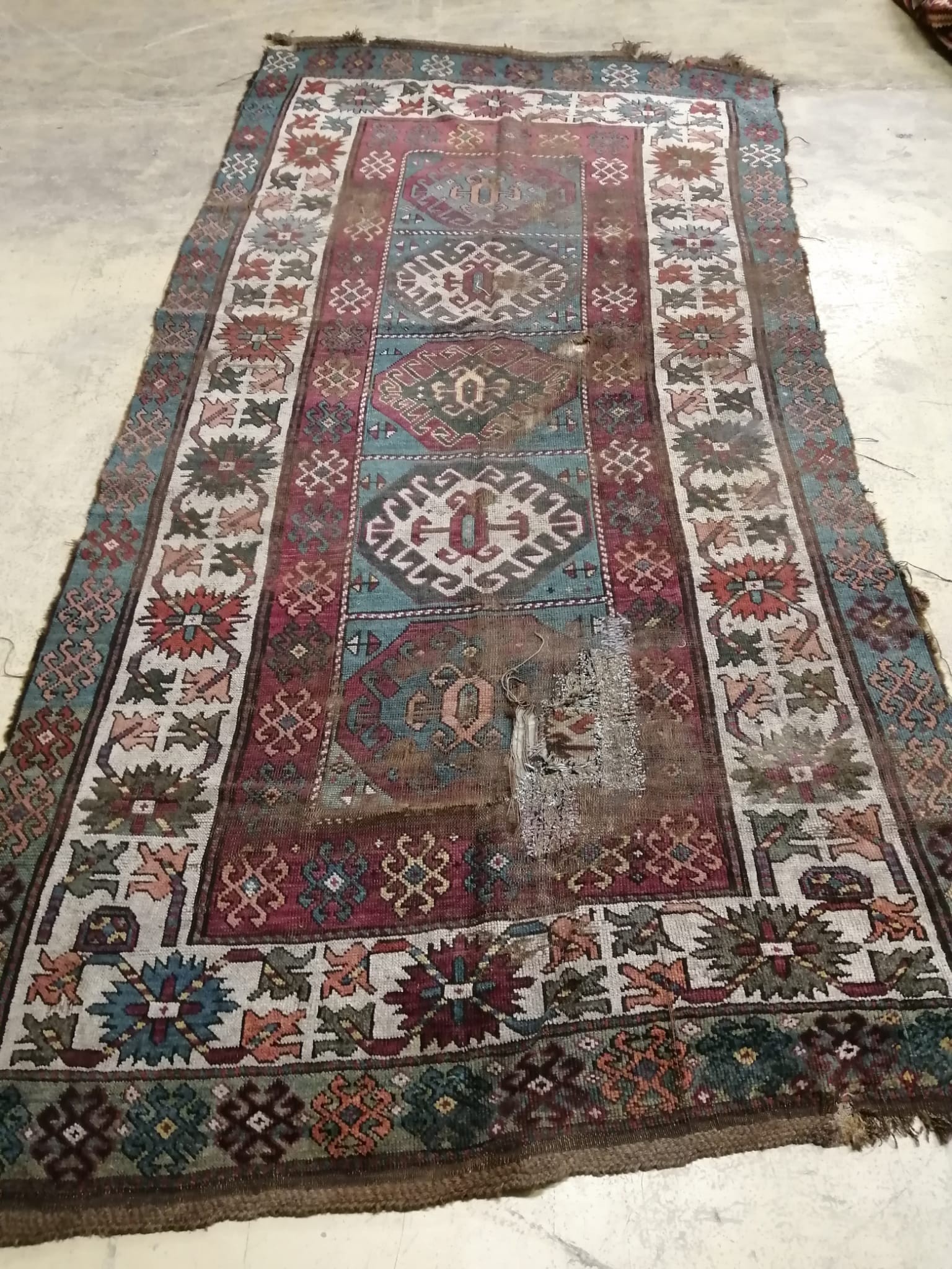 An antique Kazak rug, 310 x 150cm